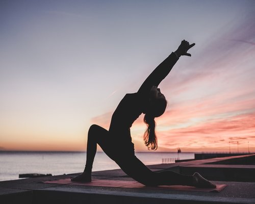 Person doing gentle stretches in the morning light