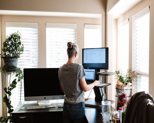Person working casually at a standing desk setup