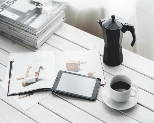 Close up of a desk with documents and a cup of coffee